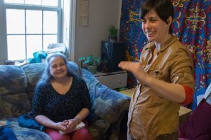 woman talking in her living room with an older woman